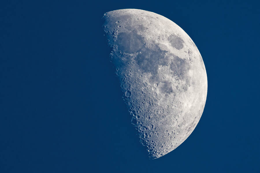 photographer dntphotographs night  photo. detailed photograph of the moon taken at half phase.