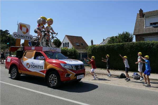 photographer Bitten by the Bug sports  photo. the caravan publicitaire travels the route of each stage of the tour de france around 2 hours or so ahead of the race  all the tours sponsors are entitled to place their weirdly modified vehicles this is incredibly