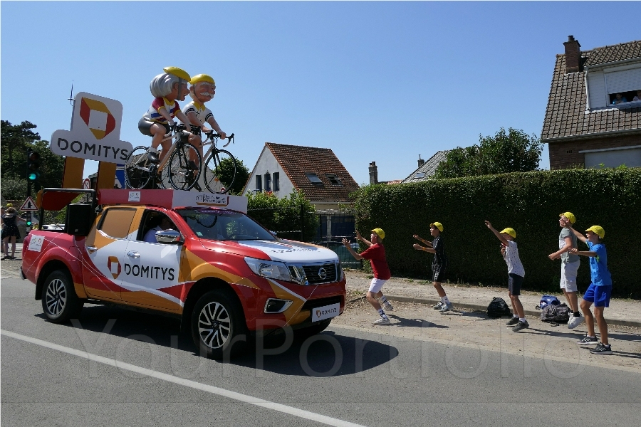 photographer Bitten by the Bug sports  photo. the caravan publicitaire travels the route of each stage of the tour de france around 2 hours or so ahead of the race  all the tours sponsors are entitled to place their weirdly modified vehicles this is incredibly